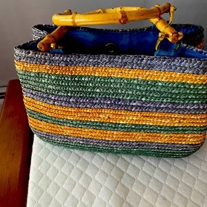 Straw purse with simulated bamboo handles.